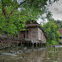 Buy canvas prints of A typical dwelling on one of the canals off the Chao Phraya river, Bangkok. by Peter Bolton