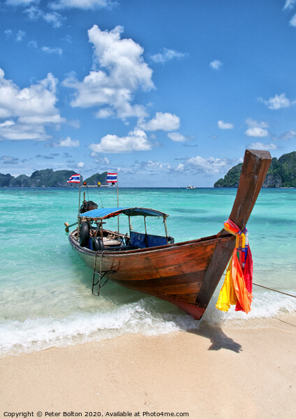 Long-tail boat pulled up on the beach, Phi Phi Island, Thailand. Picture Board by Peter Bolton