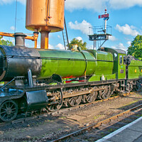 Buy canvas prints of A steam locomotive takes on water at Buckfastleigh Station, Devon, UK. by Peter Bolton