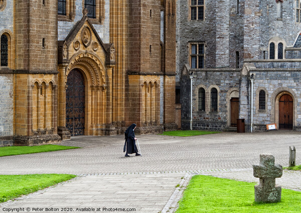 A nun crosses the courtyard at Buckfast Abbey, Dev Picture Board by Peter Bolton