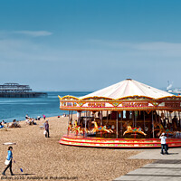 Buy canvas prints of A merry-go-round on Brighton Beach on a summer day with West Pier ruins in the background. Sussex, UK. by Peter Bolton