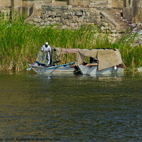 Buy canvas prints of Local fishermen moored on the Nile riverbank near Cairo, Egypt. by Peter Bolton