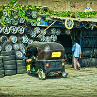 Buy canvas prints of Tyre fitter business on the outskirts of Cairo, Egypt. by Peter Bolton