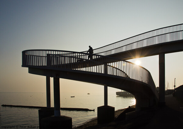 An 'abstract style' footbridge in silhouette at Leigh on Sea, Essex, UK. Picture Board by Peter Bolton