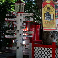 Buy canvas prints of International direction signpost in the centre of Philipsburg, St. Maarten, Caribbean. by Peter Bolton