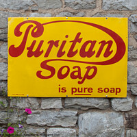 Buy canvas prints of Enamel sign advertising Puritan soap on a wall in Buckfastleigh, Devon. by Peter Bolton