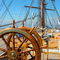 Buy canvas prints of The ships wheel and view across the deck of tall ship Khersones. Southend on sea visit. by Peter Bolton