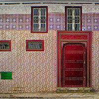 Buy canvas prints of A tiled frontage to a residence in Tetoun town, Morocco. by Peter Bolton