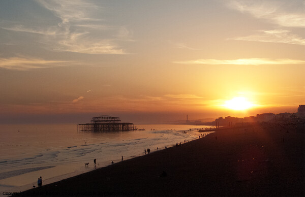 Setting sun and West Pier at Brighton, Sussex, UK. Picture Board by Peter Bolton