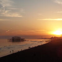 Buy canvas prints of Setting sun and West Pier at Brighton, Sussex, UK. by Peter Bolton