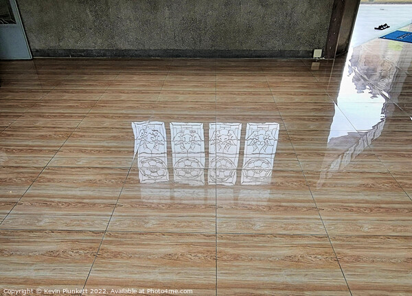 Reflected images on a shiny floor  Picture Board by Kevin Plunkett