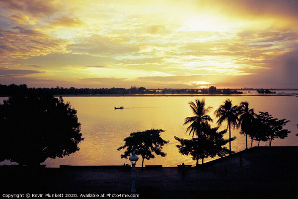 Sunrise in Phnom Penh  Picture Board by Kevin Plunkett