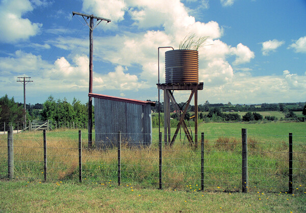 Unused water tank in the countryside in New Zealand Picture Board by Kevin Plunkett