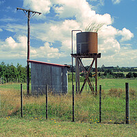 Buy canvas prints of Unused water tank in the countryside in New Zealand by Kevin Plunkett