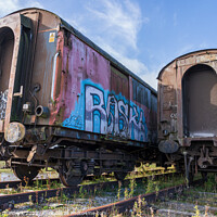 Buy canvas prints of Rusting Abandoned Railway Carriages with Graffiti by Heather Sheldrick
