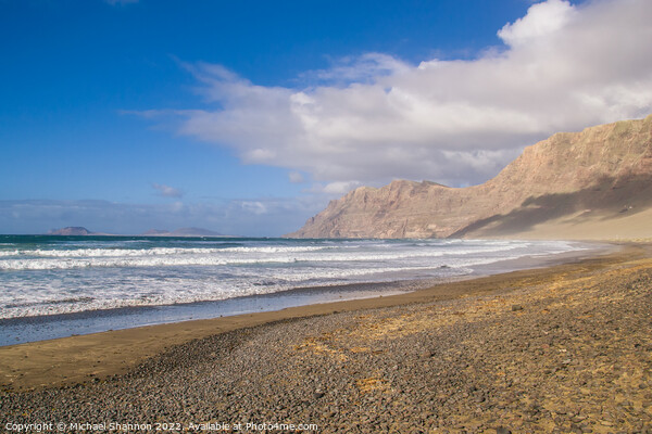 The beach and cliffs at Famara, Lanzarote Picture Board by Michael Shannon
