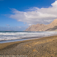 Buy canvas prints of The beach and cliffs at Famara, Lanzarote by Michael Shannon