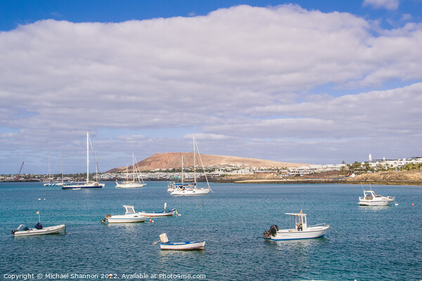 Small boats and Playa Blanca resort, Lanzarote Picture Board by Michael Shannon