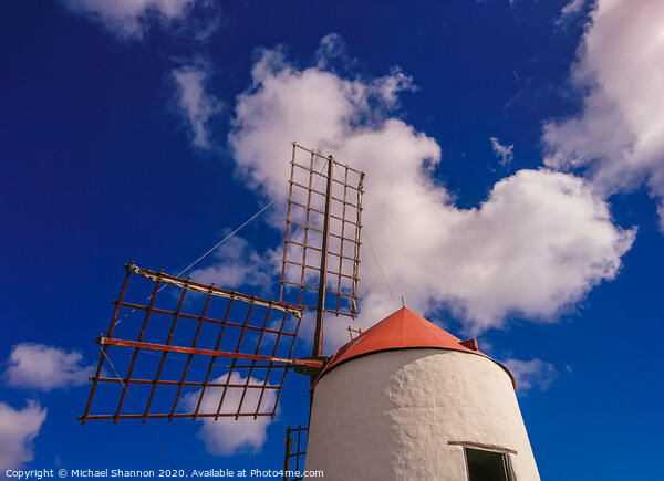 Windmill and sails on a sunny day in Lanzarote, Ca Picture Board by Michael Shannon