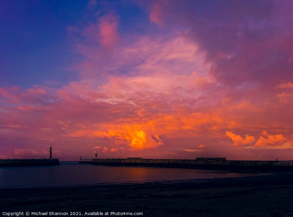 Colourful sky over the piers at Whitby in North Yo Picture Board by Michael Shannon