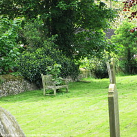 Buy canvas prints of The Memory Bench in the Church Garden.  by Sheila Eames