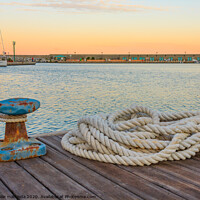 Buy canvas prints of detail of a bollard with ropes for mooring at the  by daniele mattioda