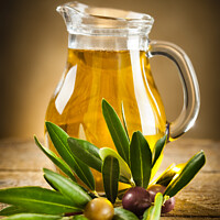 Buy canvas prints of Bottle of olive oil and an olive branch by Antonio Gravante