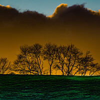 Buy canvas prints of Moody SkylineA large green field in front of a sunset by Roger Foulkes