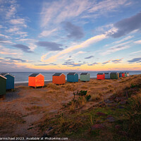 Buy canvas prints of Vibrant Beach Huts by the Calm Findhorn Bay by Janet Carmichael