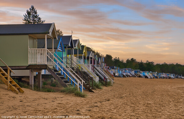 Sunset over Wells Next the Sea Beach Huts Picture Board by Janet Carmichael