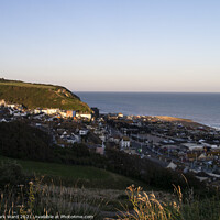 Buy canvas prints of Hastings Seafront and Old Town as the Sun goes down. by Mark Ward