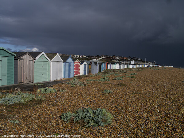 Beach Huts bathed in Sunshine and Rain. Picture Board by Mark Ward