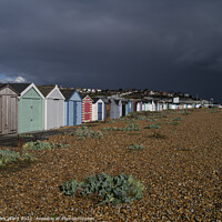 Buy canvas prints of Beach Huts bathed in Sunshine and Rain. by Mark Ward