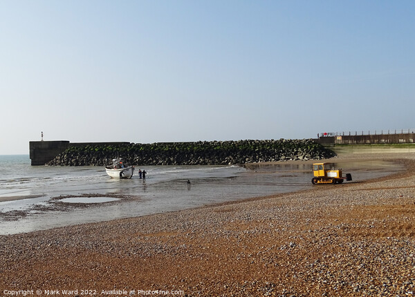 A Hastings fishing boat returning to the shingle beach. Picture Board by Mark Ward