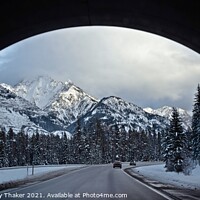 Buy canvas prints of A view of snow covered mountains and roads through an arch. by PhotOvation-Akshay Thaker
