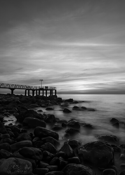 Dark sunrise on the pebble beach in black and white Picture Board by Vicen Photo
