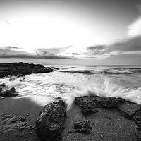 Buy canvas prints of A wave crashing against the rock on a beach in black and white by Vicen Photo