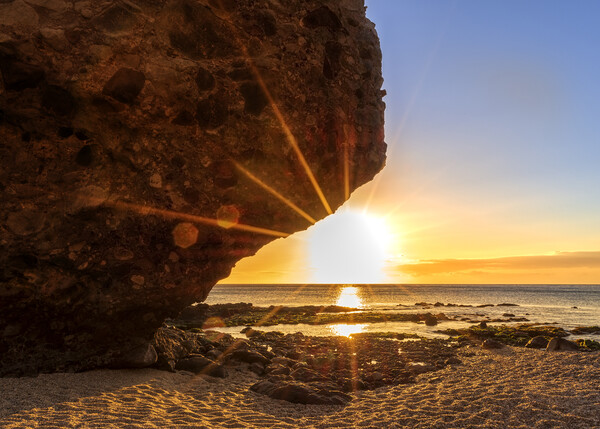 Photography with the sunrise sun behind the rock of the beach of the dead Picture Board by Vicen Photo