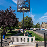 Buy canvas prints of Vacant seat High Street Bourton-on-the-Water. by Allan Bell
