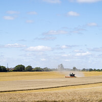 Buy canvas prints of Combine harvester reaping a wheat crop by Allan Bell