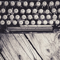Buy canvas prints of Old and weathered antique typewriter keyboard on wooden background in greyscale. by Kristof Bellens