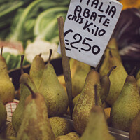 Buy canvas prints of Italian Abate pears with price tag for sale in a market stall. by Kristof Bellens