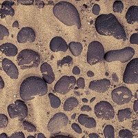 Buy canvas prints of Directly above shot of lava stones in the sand by Kristof Bellens