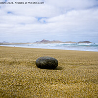 Buy canvas prints of Empty beach with black stone in the foreground by Kristof Bellens