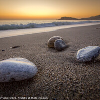 Buy canvas prints of Sea-washed pebbles on a quiet sandy Mediterranean  by Alexander Volkov