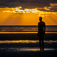 Buy canvas prints of Anthony Gormley Statue standing on a beach in fron by Vicky Outen