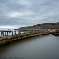 Buy canvas prints of Whitby Pier with the lighthouse & Whitby Abbey in the distance.  by Vicky Outen