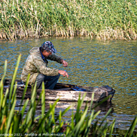 Buy canvas prints of A fisherman in a wooden boat is fishing.  by Vitalii Kryvolapov