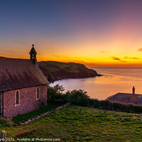 Buy canvas prints of A sunset over the sea with a church in the foreground by Gary Holpin
