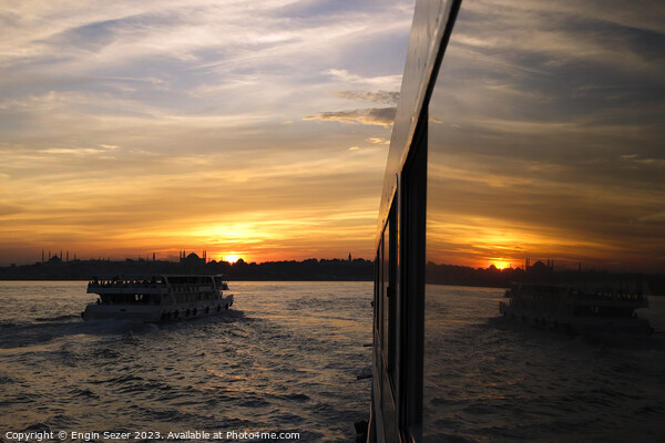 A sunset in Istanbul with the reflections on a boats windows 2 Picture Board by Engin Sezer